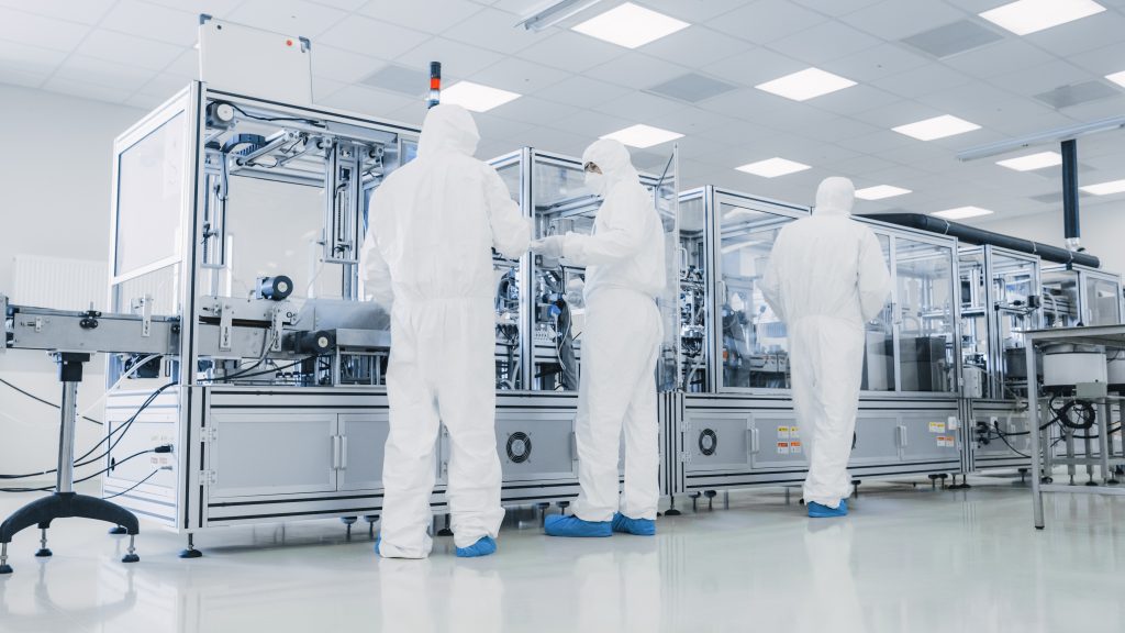 a group of people in white hazmat suits